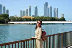 天际线沙迦可见海滨女人旅游背包享受视图水摩天大楼城市景观沙迦阿联酋