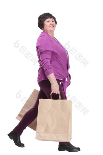 休闲上了年纪的女人购物袋大步向前