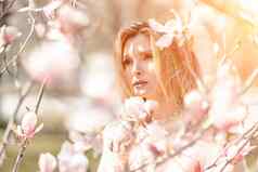 木兰女人肖像快乐中间岁的女人享受气味盛开的春天花园美丽的木兰灌木大花