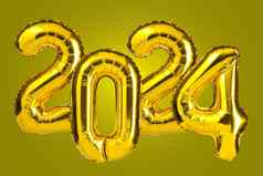 一年庆祝活动金黄色的箔颜色气球气球黄色的背景