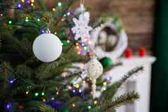 白色圣诞节树小玩意挂起分支随行人员站生活房间