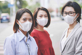 集团年轻的亚洲女性抗菌面具搁浅城市街