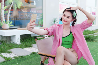 快乐的青年女人用<strong>手机</strong>拍照中国照片