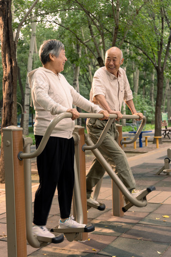 公园里使用锻炼<strong>器材</strong>锻炼的老年夫妇休闲活动