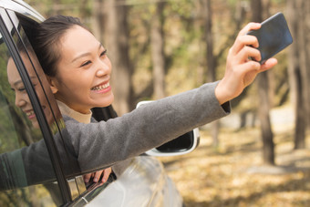 年轻女人户外郊游幸福手机秋游摄影图