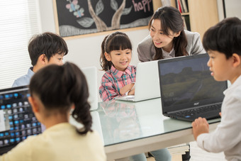 老师<strong>指导学生</strong>使用电脑幼儿园休闲装摄影图