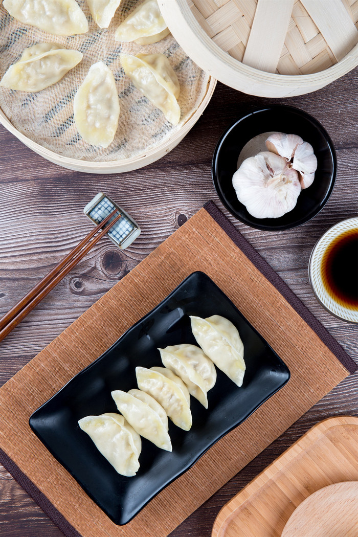 俯拍蒸笼里面水饺和大蒜图片