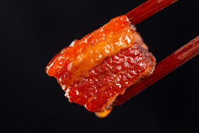 黑色拍摄筷子夹起红烧肉