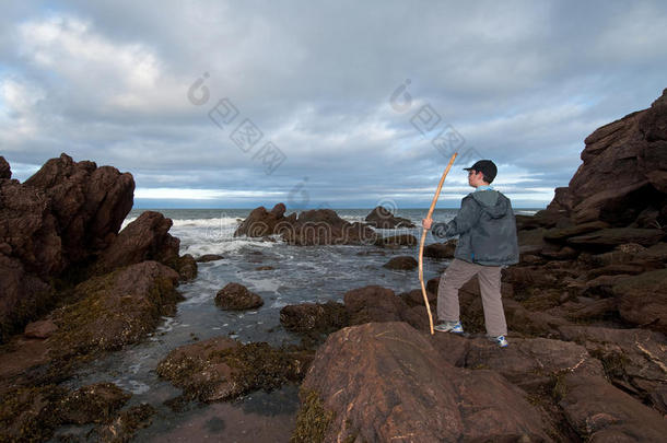 男孩看海和岩石