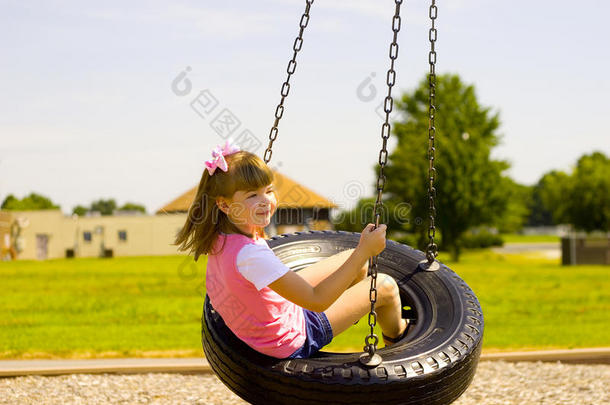 在公园玩轮胎秋千的孩子