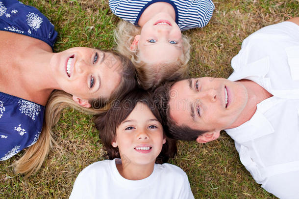 快乐的一家人围成一圈躺在草地上