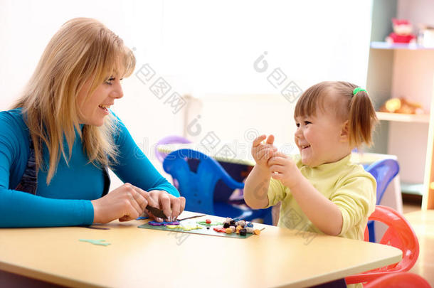 老师和小女孩玩橡皮泥