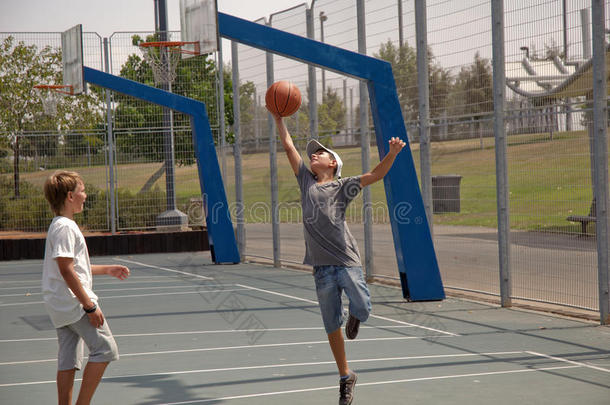 两个男孩在打篮球。