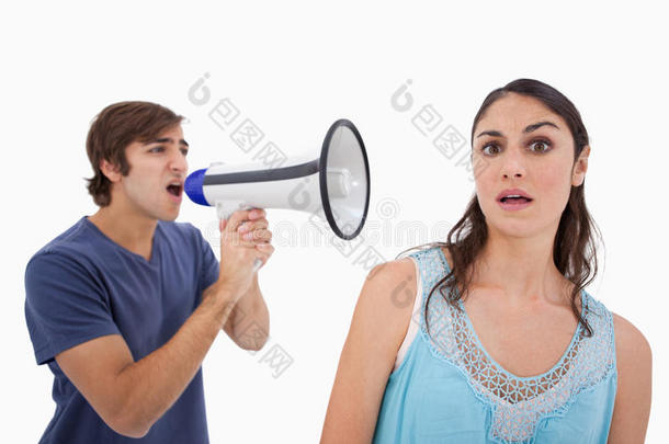 一个男人用扩音器对她的女朋友大喊大叫