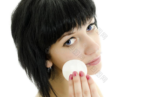 用棉签擦脸的女人。