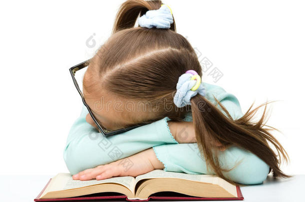 小女孩睡在书上
