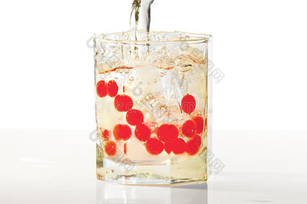 一杯朗姆酒，冰和红蔓越莓，溅起水花