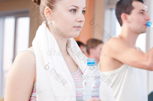 男女运动后在健身房喝水