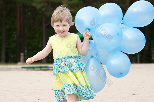 快乐微笑的小女孩带着气球奔跑