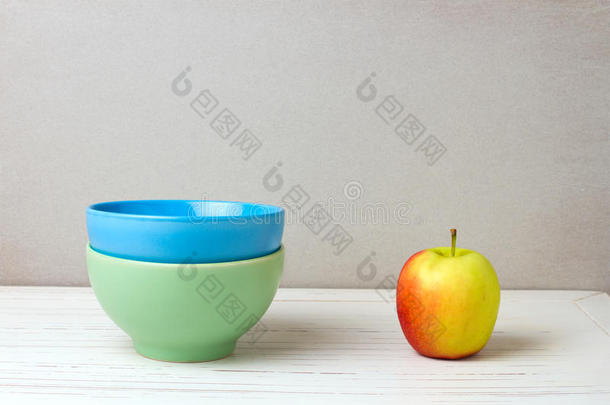 两个五颜六色的碗和苹果