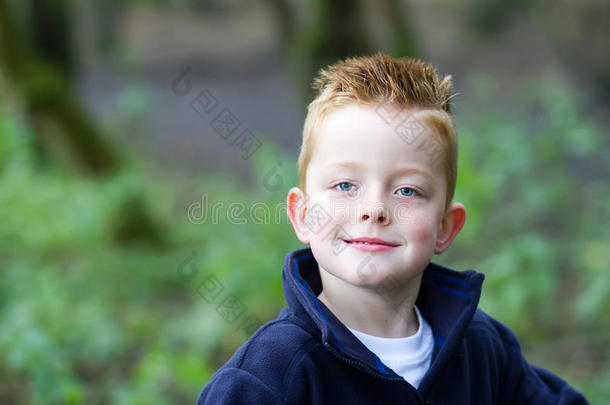 在树林里微笑的小男孩