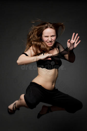 年轻漂亮的女人跳上黑色的图片