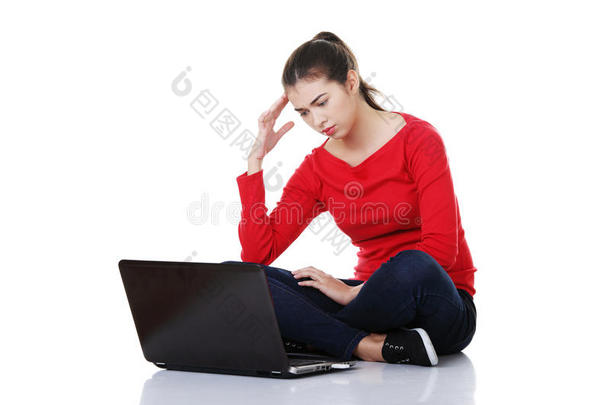 伤心的女人看着笔记本电脑屏幕。