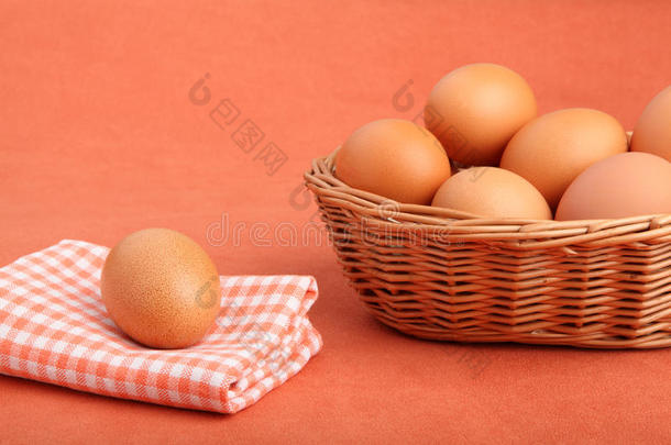 古董桌布上的棕色鸡蛋和篮子里的鸡蛋