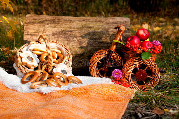 秋季野餐：一篮子百吉饼和苹果放在柳条车里