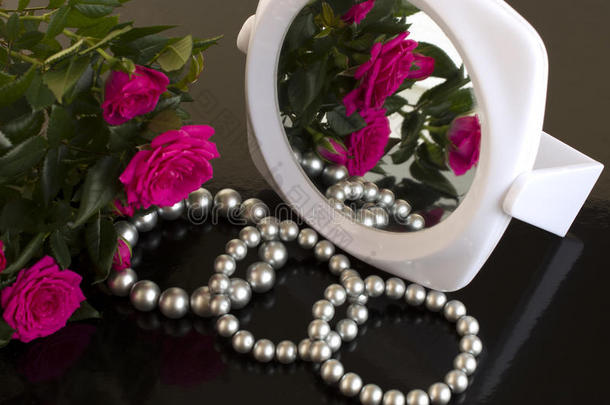 珍珠手镯、玫瑰花束和镜子
