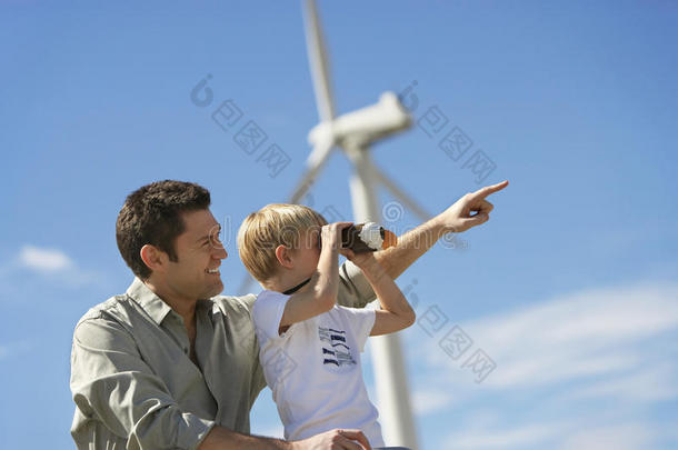 在风电场和父亲在一起的男孩