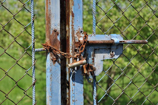 带锁的旧蓝色栅栏