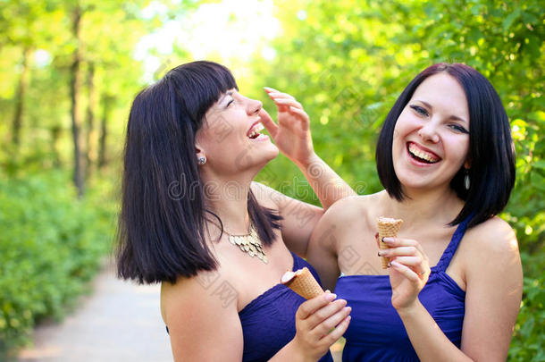 夏日公园里两个拿着冰激凌的笑女人
