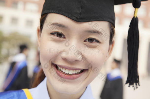 微笑着的年轻女<strong>毕业</strong>生戴着摩托瓦德的特写照片