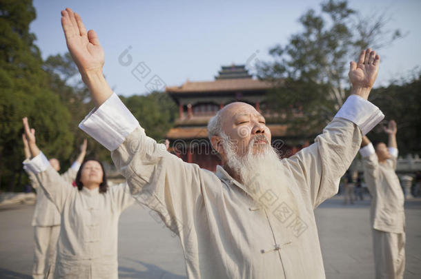 中国人在中国传统建筑前练习太极拳