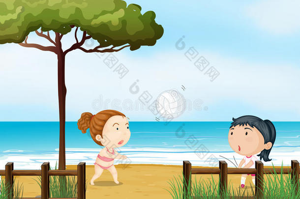 两个小女孩在沙滩上打排球