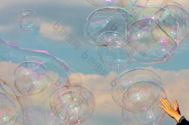 泡泡孩子们的手伸手去抓在微风中漂浮的泡泡