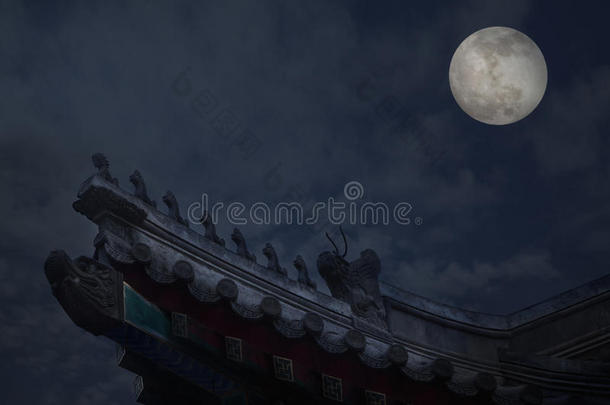 <strong>月色</strong>背景的中国建筑装饰屋顶瓷砖特写，夜晚。