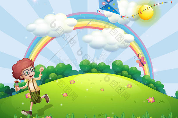 一个男孩在山顶上用彩虹玩风筝