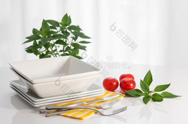 白桌子上的盘子和厨房用具