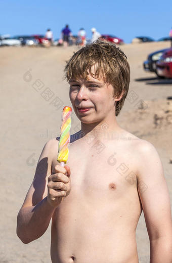 暑假：可爱的孩子在沙滩上吃冰淇淋图片