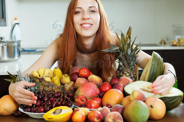 一个快乐的长发女孩，带着一堆水果
