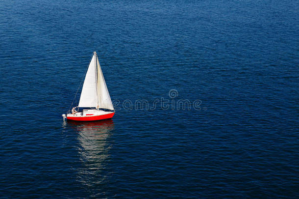 平静的蓝色海面上的白色孤帆