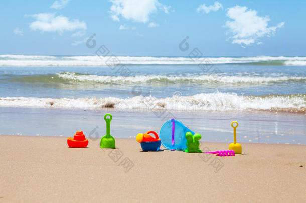 沙滩上的塑料沙滩玩具，背景是大海