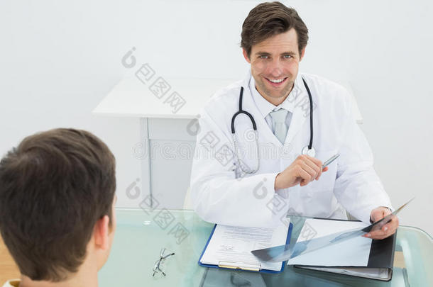 微笑的医生向病人解释x光报告