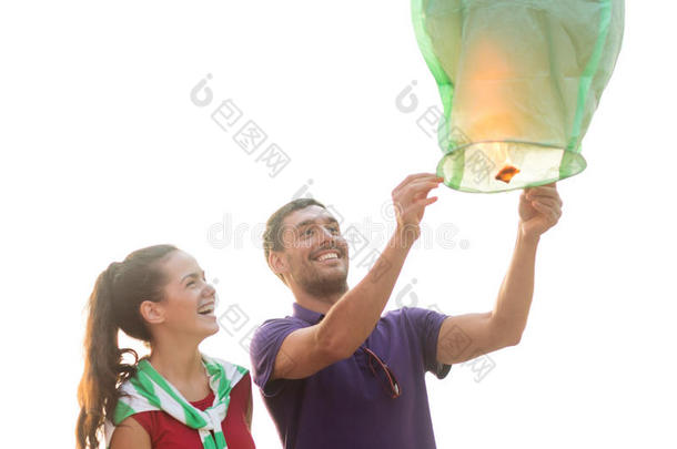 沙滩上挂着中国天灯的情侣
