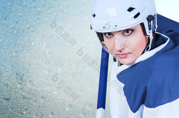 美丽的冰球女运动员时尚肖像在冰背景上