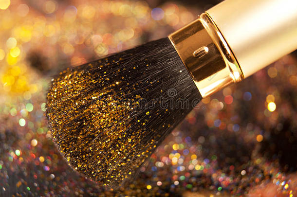 金色画笔和闪亮粉末特写