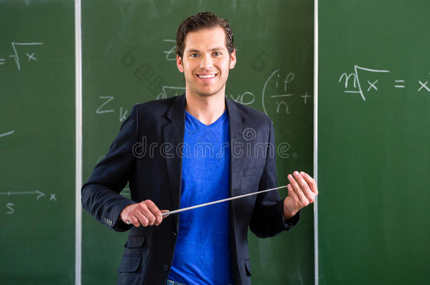 老师拿着教鞭站在教室前面