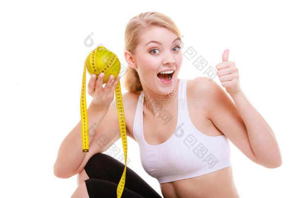 运动<strong>型身材</strong>的女士，带着水果卷尺。是时候减肥了。